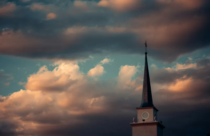 A church steeple against a dramatic evening sky