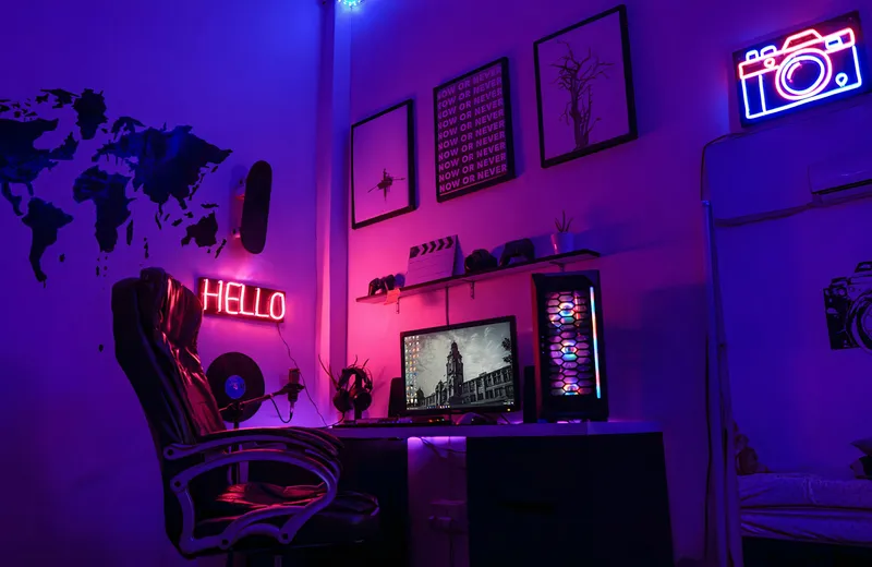 A creator workspace with monitors and colored lighting