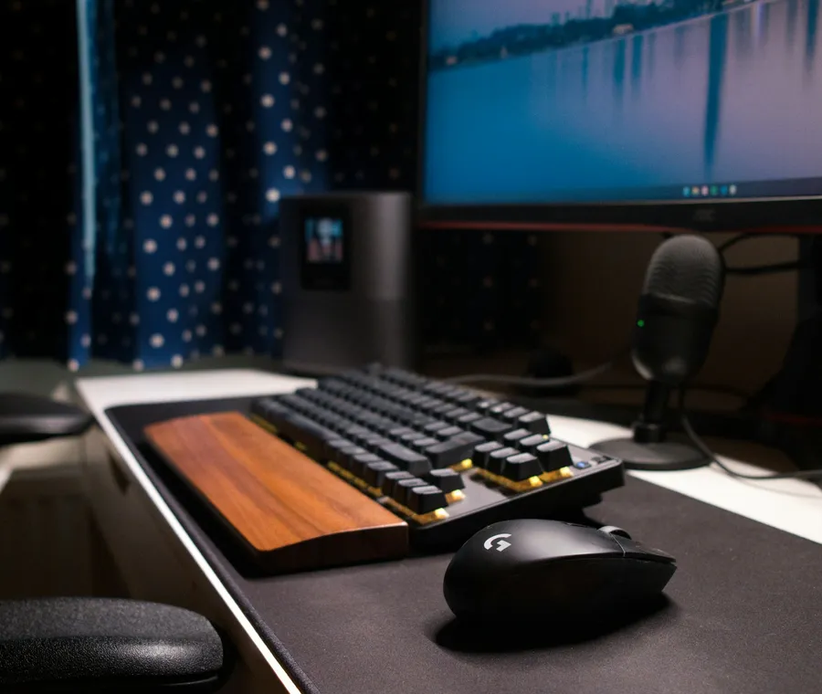 A tidy workstation with a monitor and keyboard in a dim office